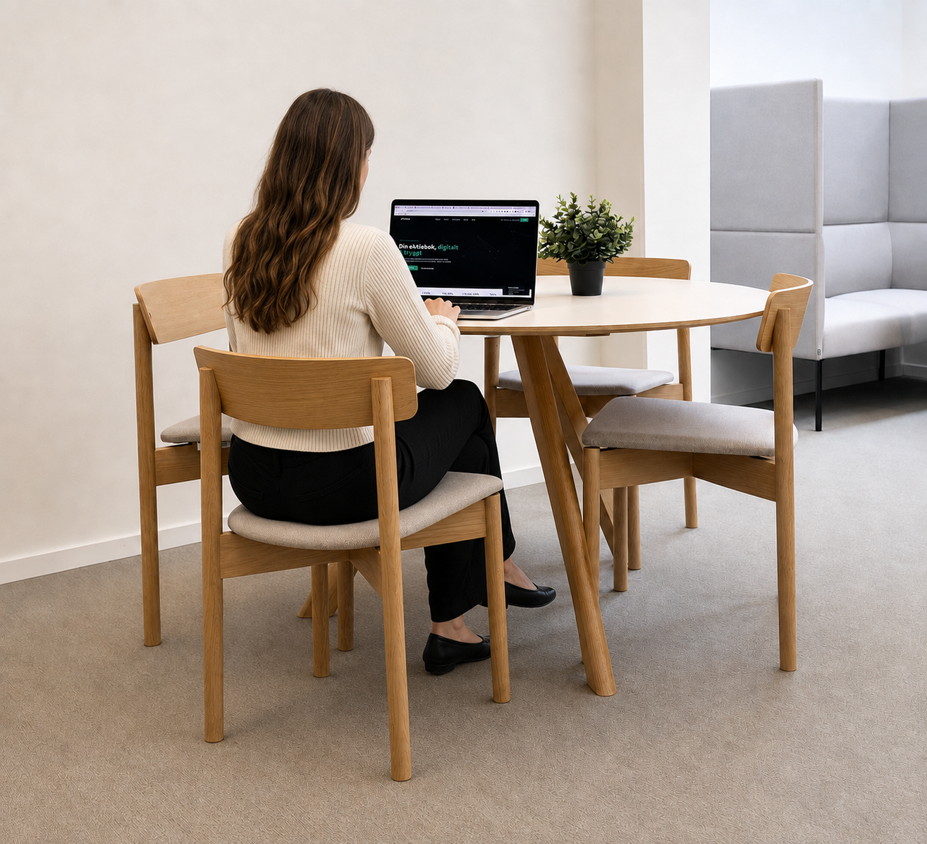 Woman working with eAktiebok's digital share register at a bright desk in Malmö