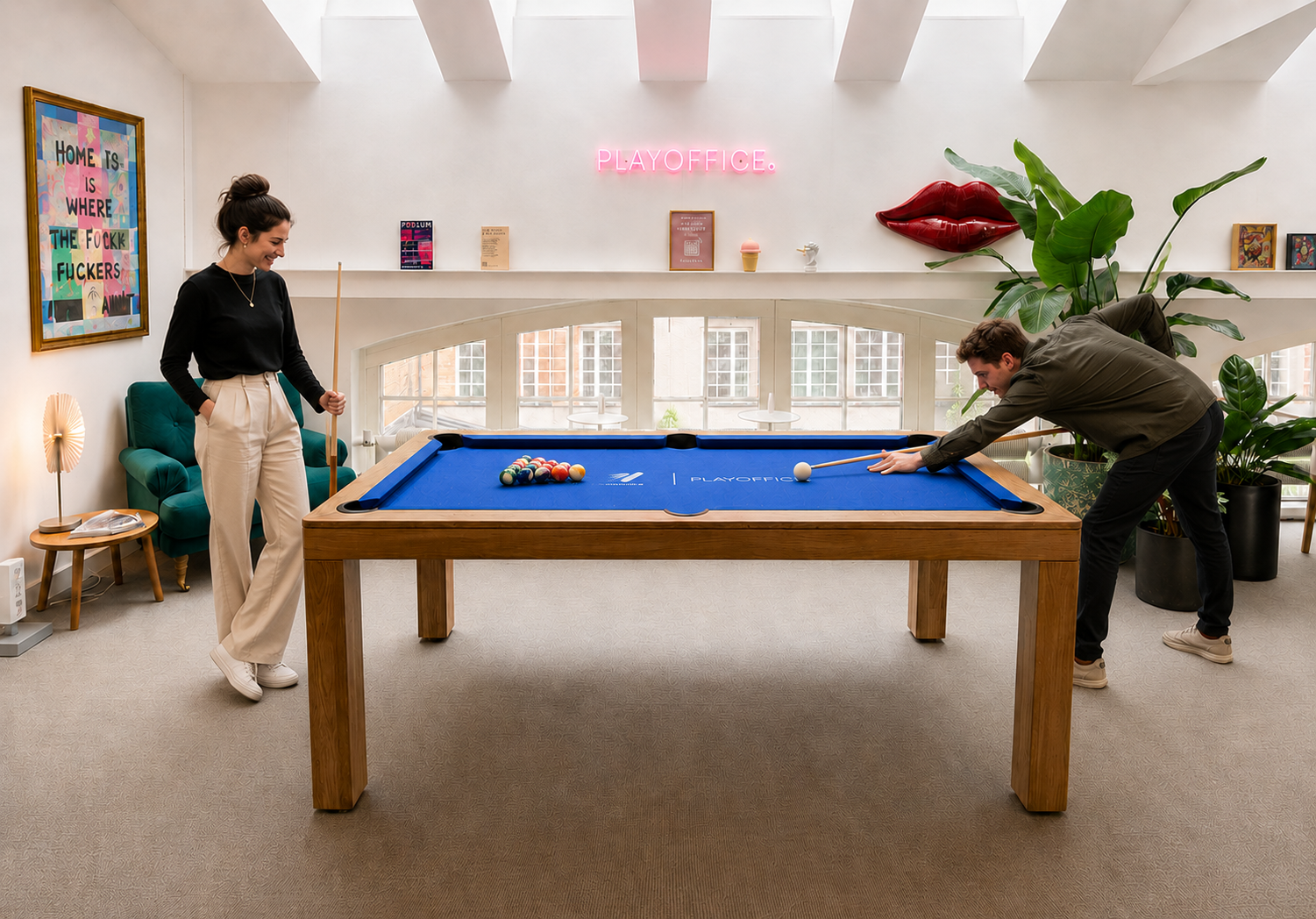 Colleagues playing pool in a creative office environment and building community around eAktiebok