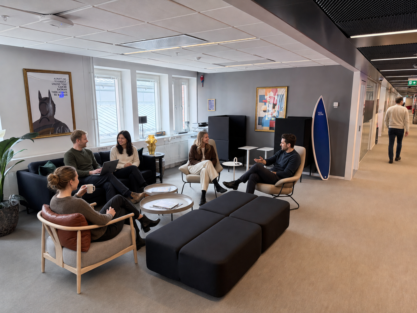 Colleagues collaborating in eAktiebok's modern office environment